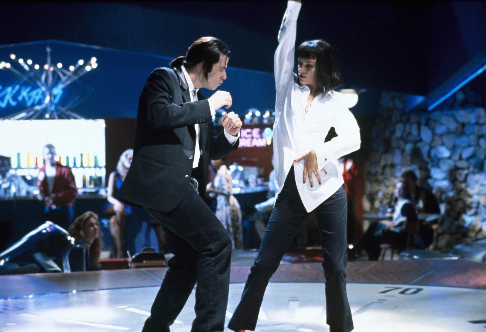 Pulp Fiction still showing Vincent and Mia at the retro-themed restaurant